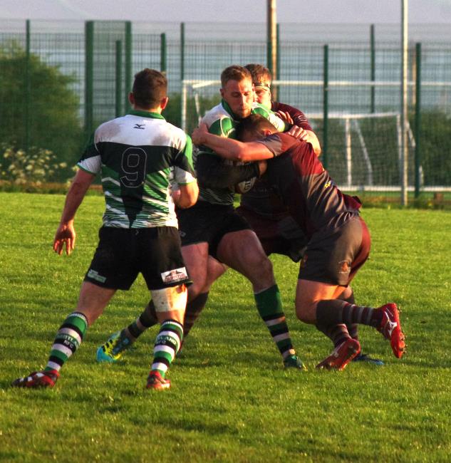Whitland centre Josh Thomas is stopped in his tracks by Sion Colella
